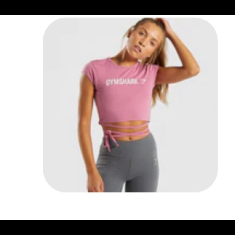 Gymshark pink crop top with ribbon ties. Also never worn.